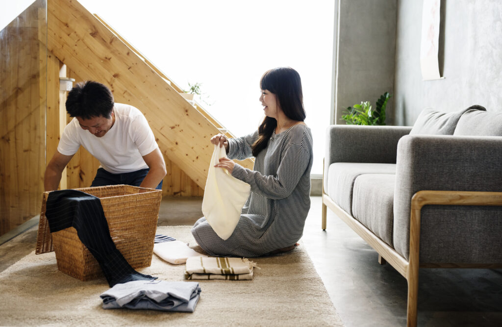 Couple sitting together folding laundry, understanding neurodivergence in relationships.
