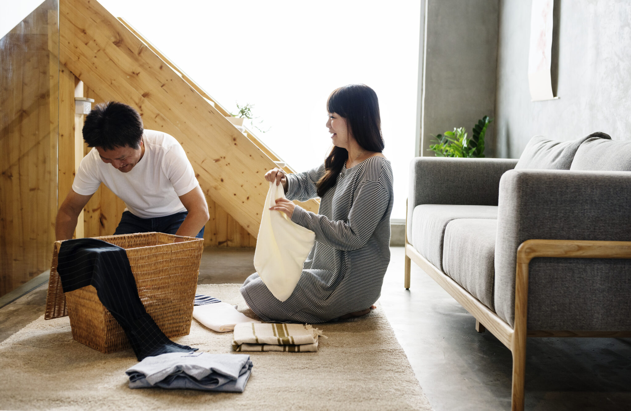 Couple sitting together folding laundry, understanding neurodivergence in relationships.