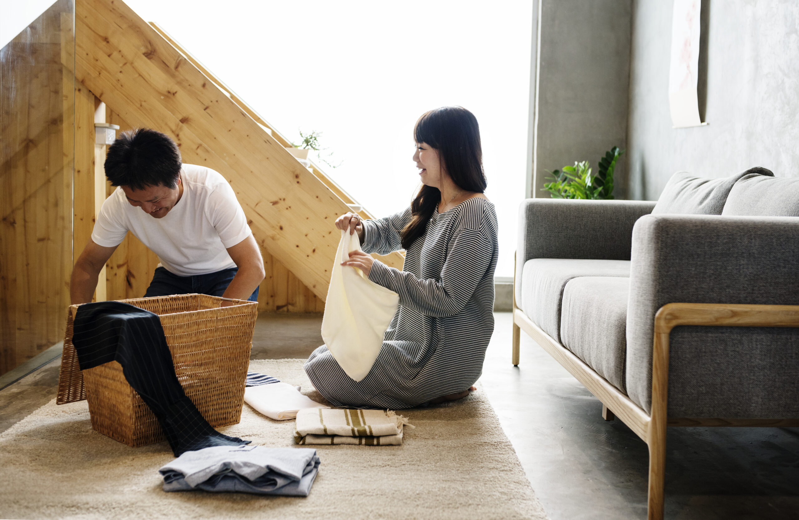 Couple sitting together folding laundry, understanding neurodivergence in relationships.