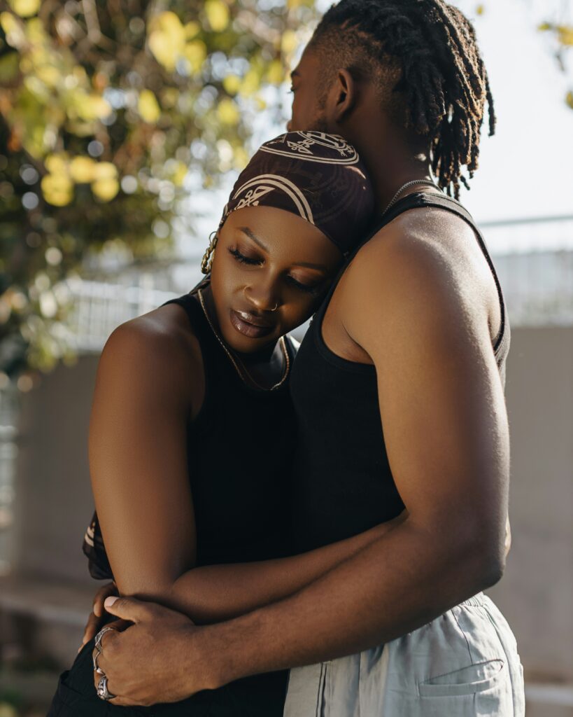 The Act of Repair: What Happens When We Get It Wrong 1 A couple embracing outdoors in warm sunlight, reconnecting after conflict: the act of repair.